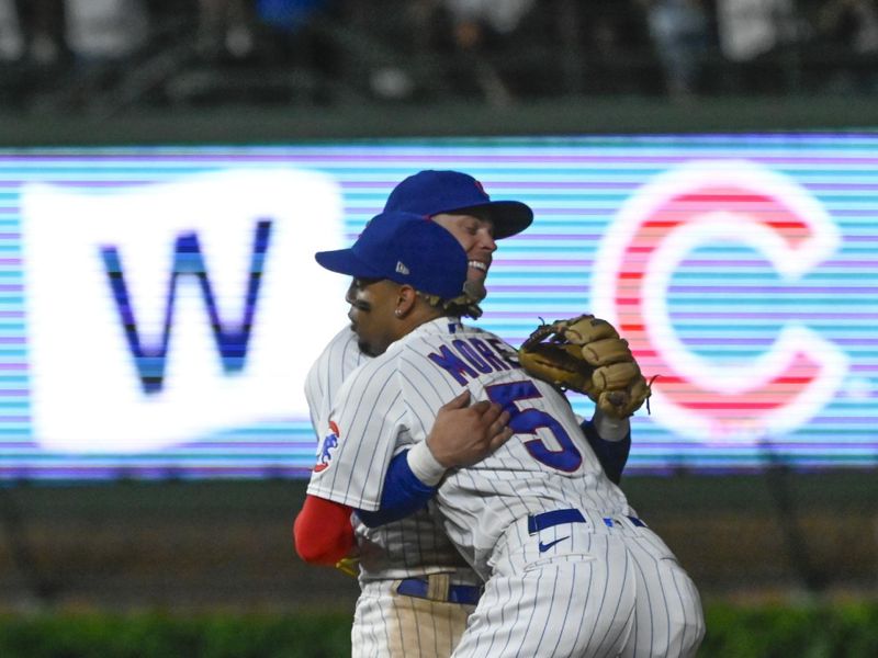 Jul 19, 2023; Chicago, Illinois, USA;  Chicago Cubs second baseman Nico Hoerner (2), back, is hugged by Chicago Cubs center fielder Christopher Morel (5) at the end of the game against the Washington Nationals at Wrigley Field. Mandatory Credit: Matt Marton-USA TODAY Sports