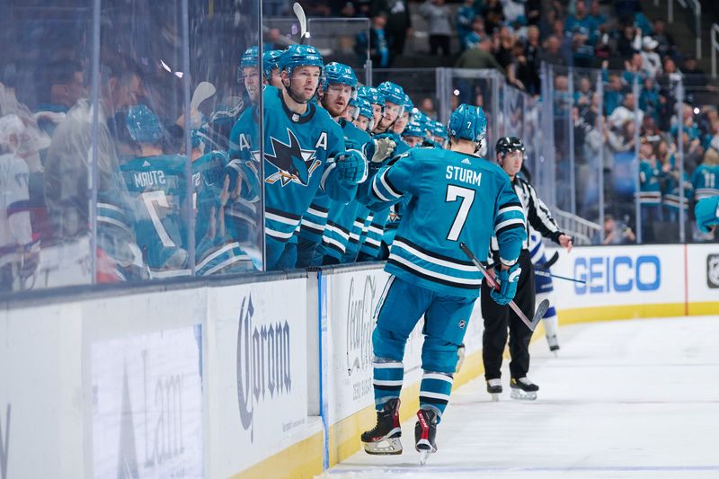 Oct 29, 2022; San Jose, California, USA; San Jose Sharks center Nico Sturm (7) shakes hands with players on the bench after scoring a goal against the Tampa Bay Lightning during the second period at SAP Center at San Jose. Mandatory Credit: Robert Edwards-USA TODAY Sports