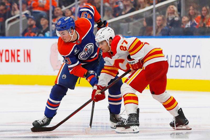 Sep 23, 2024; Edmonton, Alberta, CAN; Calgary Flames forward Matt Coronato (27) and Edmonton Oilers forward Matvey Petrov (43) battles for position during the third period at Rogers Place. Mandatory Credit: Perry Nelson-Imagn Images