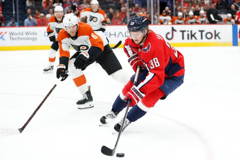 Oct 23, 2024; Washington, District of Columbia, USA; Washington Capitals defenseman Rasmus Sandin (38) skates with the puck as Philadelphia Flyers defenseman Travis Sanheim (6) defends in the first period at Capital One Arena. Mandatory Credit: Geoff Burke-Imagn Images