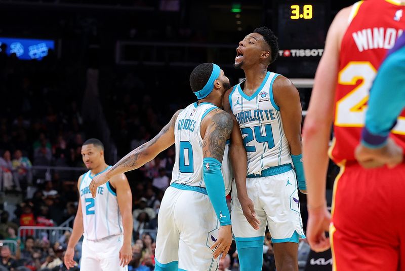 ATLANTA, GEORGIA - APRIL 10:  Miles Bridges #0 of the Charlotte Hornets reacts with Brandon Miller #24 after hitting the game-winning basket against the Atlanta Hawks in the final seconds of the fourth quarter at State Farm Arena on April 10, 2024 in Atlanta, Georgia.  NOTE TO USER: User expressly acknowledges and agrees that, by downloading and/or using this photograph, user is consenting to the terms and conditions of the Getty Images License Agreement.  (Photo by Kevin C. Cox/Getty Images)