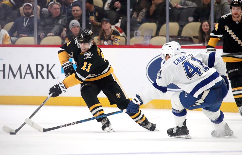 Nov 19, 2024; Pittsburgh, Pennsylvania, USA;  Pittsburgh Penguins center Vasily Ponomarev (11) skates with the puck against Tampa Bay Lightning defenseman Darren Raddysh (43) during the third period at PPG Paints Arena. Mandatory Credit: Charles LeClaire-Imagn Images