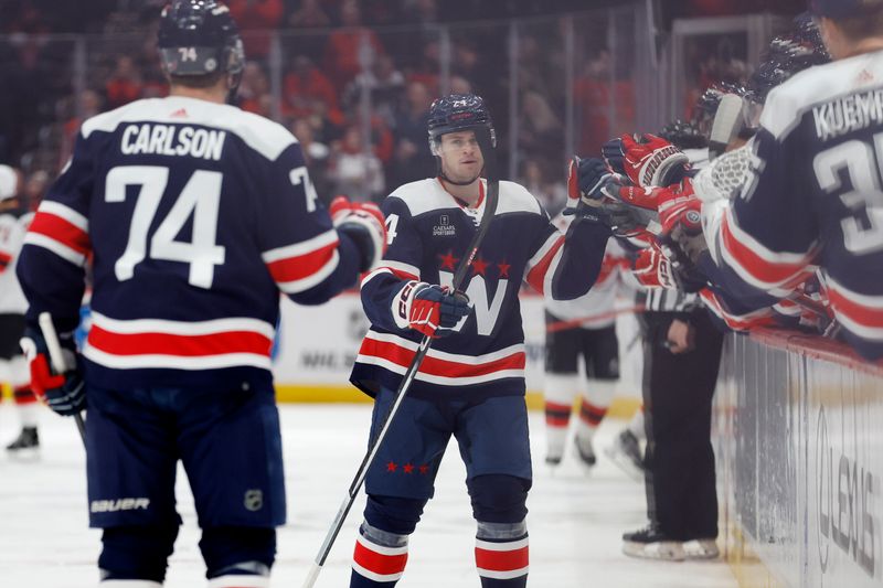 Feb 20, 2024; Washington, District of Columbia, USA; Washington Capitals center Connor McMichael (24) celebrates with teammates after scoring a goal against the New Jersey Devils in the first period at Capital One Arena. Mandatory Credit: Geoff Burke-USA TODAY Sports