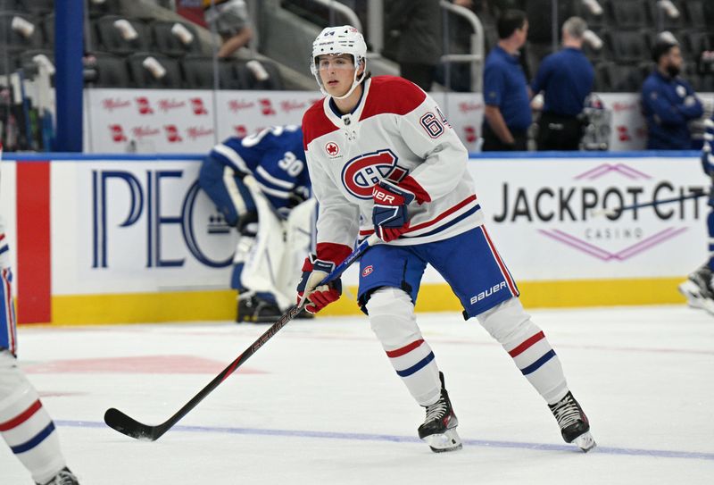 Sep 26, 2024; Toronto, Ontario, CAN;  Montreal Canadiens defenseman David Reinbacher (64) warms up before playing the Toronto Maple Leafs at Scotiabank Arena. Mandatory Credit: Dan Hamilton-Imagn Images