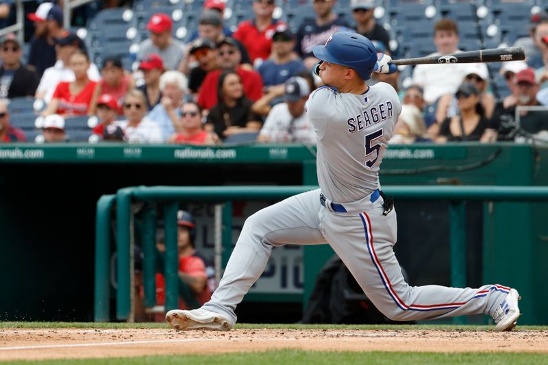 Jul 9, 2023; Washington, District of Columbia, USA; Texas Rangers shortstop Corey Seager (5) singles against the Washington Nationals during the fourth inning at Nationals Park. Mandatory Credit: Geoff Burke-USA TODAY Sports