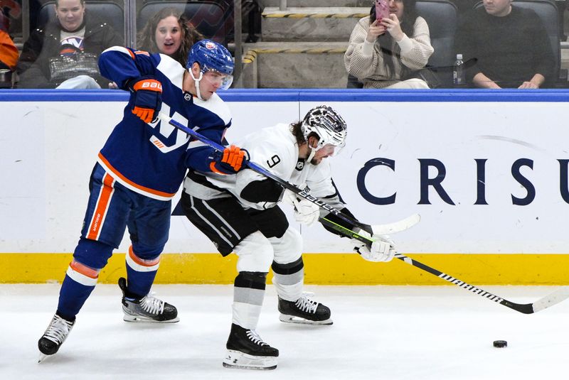 Dec 9, 2023; Elmont, New York, USA; New York Islanders center Bo Horvat (14) defends against Los Angeles Kings right wing Adrian Kempe (9) during the third period at UBS Arena. Mandatory Credit: John Jones-USA TODAY Sports