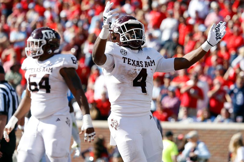 Nov 4, 2023; Oxford, Mississippi, USA; Texas A&M Aggies running back Amari Daniels (4) reacts after a touchdown during the second half against the Mississippi Rebels at Vaught-Hemingway Stadium. Mandatory Credit: Petre Thomas-USA TODAY Sports