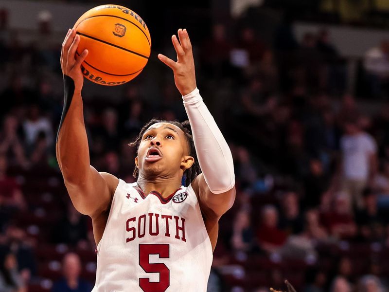 Mar 4, 2023; Columbia, South Carolina, USA; South Carolina Gamecocks guard Meechie Johnson (5) drives past Georgia Bulldogs guard Mardrez McBride (13) in the first half at Colonial Life Arena. Mandatory Credit: Jeff Blake-USA TODAY Sports