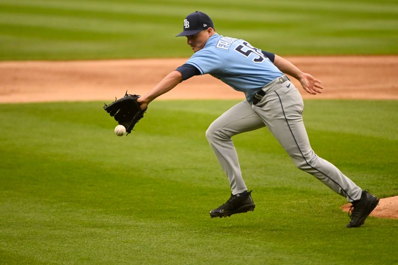 Apr 29, 2023; Chicago, Illinois, USA;  Tampa Bay Rays pitcher Calvin Faucher (58) fields a ball hit by Chicago White Sox center fielder Luis Robert Jr. (88) during the first inning at Guaranteed Rate Field. Mandatory Credit: Matt Marton-USA TODAY Sports