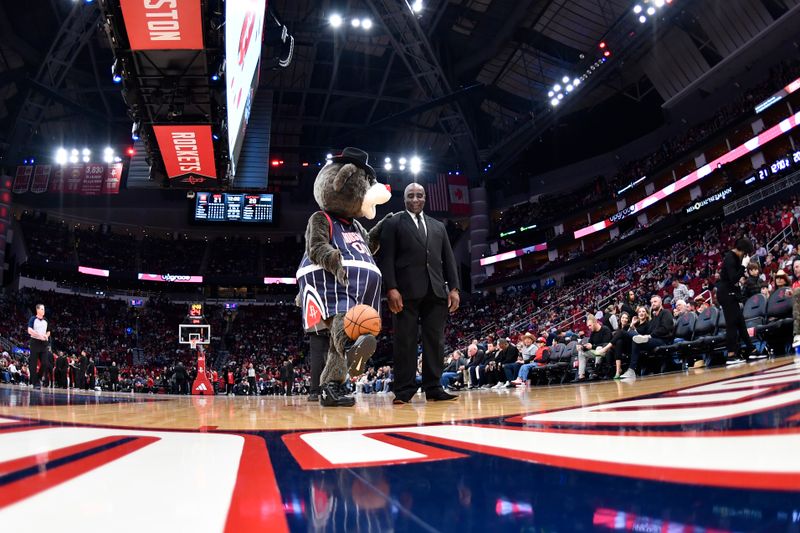 HOUSTON, TX - FEBRUARY 3: (EDITORS NOTE: Image captured through a circular fisheye lens) Mascot Clutch the Bear of the Houston Rockets interacts with security during a timeout on February 3, 2023 at the Toyota Center in Houston, Texas. NOTE TO USER: User expressly acknowledges and agrees that, by downloading and or using this photograph, User is consenting to the terms and conditions of the Getty Images License Agreement. Mandatory Copyright Notice: Copyright 2023 NBAE (Photo by Logan Riely/NBAE via Getty Images)