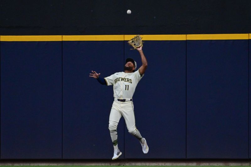 May 17, 2025; Milwaukee, Wisconsin, USA; Milwaukee Brewers center fielder Jackson Chourio (11) catches ball hit by Minnesota Twins catcher Christian Vazquez (not pictured) in the fourth inning at American Family Field. Mandatory Credit: Benny Sieu-Imagn Images