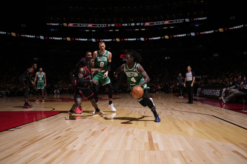 TORONTO, CANADA - JANUARY 15:  Jrue Holiday #4 of the Boston Celtics handles the ball during the game against the Toronto Raptors on January 15, 2024 at the Scotiabank Arena in Toronto, Ontario, Canada.  NOTE TO USER: User expressly acknowledges and agrees that, by downloading and or using this Photograph, user is consenting to the terms and conditions of the Getty Images License Agreement.  Mandatory Copyright Notice: Copyright 2024 NBAE (Photo by Mark Blinch/NBAE via Getty Images)