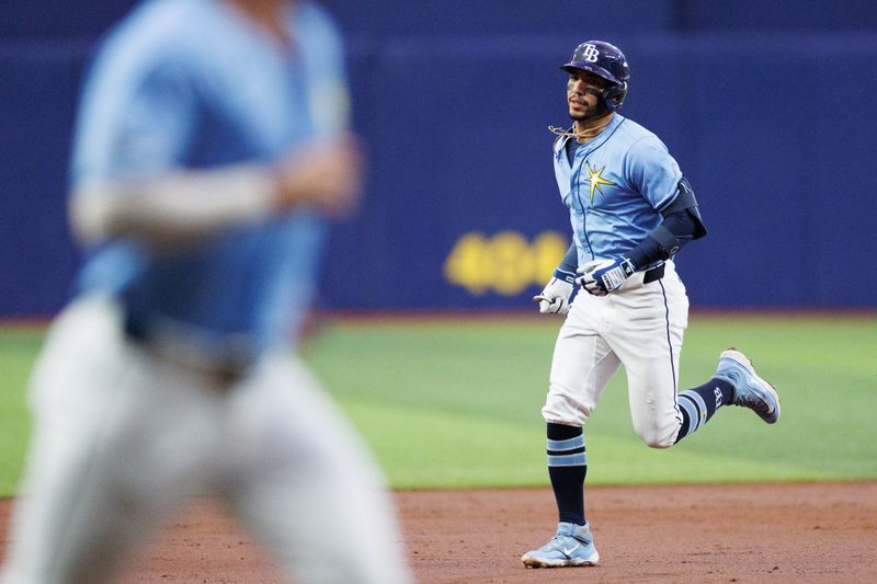 Jun 30, 2024; St. Petersburg, Florida, USA;  Tampa Bay Rays shortstop Jose Caballero (7) runs the bases after hitting a two-run home run against the Washington Nationals in the second inning at Tropicana Field. Mandatory Credit: Nathan Ray Seebeck-USA TODAY Sports