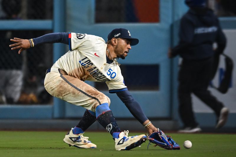 Sep 21, 2024; Los Angeles, California, USA; Los Angeles Dodgers outfielder Mookie Betts (50) misses a catch against the Colorado Rockies during the ninth inning at Dodger Stadium. Mandatory Credit: Jonathan Hui-Imagn Images