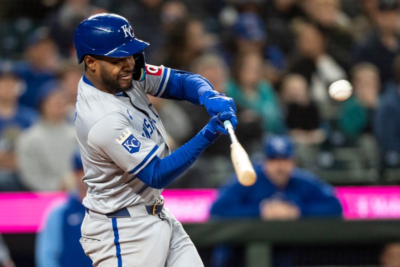 May 13, 2024; Seattle, Washington, USA; Kansas City Royals third baseman Maikel Garcia (11) hits a single during the eighth inning against the Seattle Mariners at T-Mobile Park. Mandatory Credit: Stephen Brashear-USA TODAY Sports