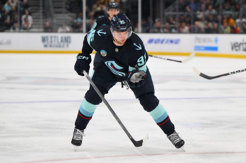 Mar 16, 2024; Seattle, Washington, USA; Seattle Kraken left wing Andre Burakovsky (95) palms the puck during the second period against the Nashville Predators at Climate Pledge Arena. Mandatory Credit: Steven Bisig-USA TODAY Sports