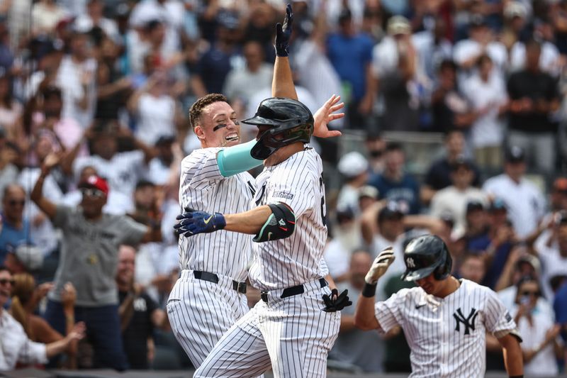 Aug 25, 2024; Bronx, New York, USA;  New York Yankees designated hitter Giancarlo Stanton (27) celebrates with center fielder Aaron Judge (99) after hitting a solo home run in the seventh inning against the Colorado Rockies at Yankee Stadium. Mandatory Credit: Wendell Cruz-USA TODAY Sports
