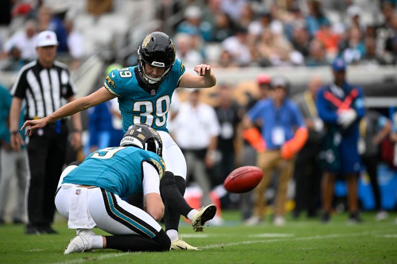 Jacksonville Jaguars place kicker Cam Little (39) kicks a field goal out of the hole of Logan Cooke during the first half of an NFL football game against the Indianapolis Colts, Sunday, Oct. 6, 2024, in Jacksonville, Fla. (AP Photo/Phelan M. Ebenhack)