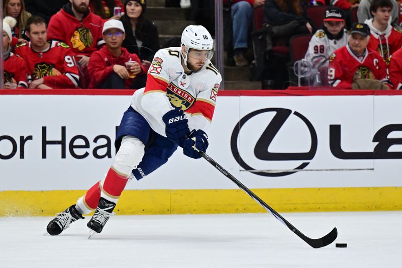 Nov 21, 2024; Chicago, Illinois, USA; Florida Panthers left wing A.J. Greer (10) skates with the puck against the Chicago Blackhawks during the second period at the United Center. Mandatory Credit: Daniel Bartel-Imagn Images