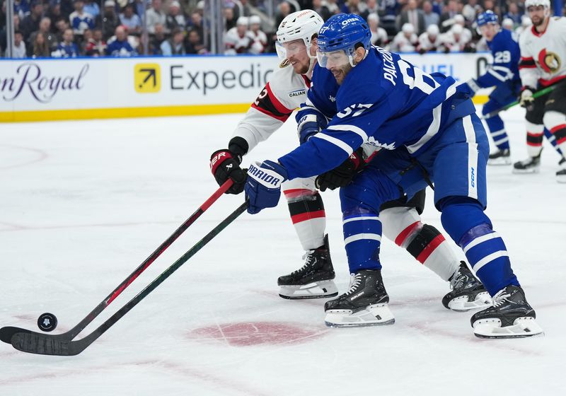 Apr 29, 2025; Toronto, Ontario, CAN;Toronto Maple Leafs left wing Max Pacioretty (67) battles for the puck with Ottawa Senators defenseman Thomas Chabot (72) in the third period during game five of the first round of the 2025 Stanley Cup Playoffs at Scotiabank Arena. Mandatory Credit: Nick Turchiaro-Imagn Images