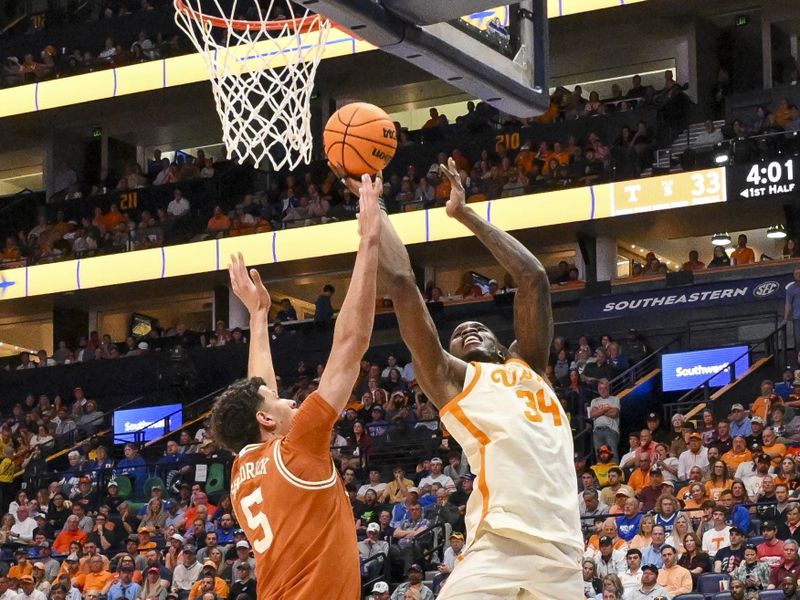 Mar 14, 2025; Nashville, TN, USA;  Tennessee Volunteers forward Felix Okpara (34) shoots over  Texas Longhorns forward Kadin Shedrick (5) during the second half at Bridgestone Arena. Mandatory Credit: Steve Roberts-Imagn Images