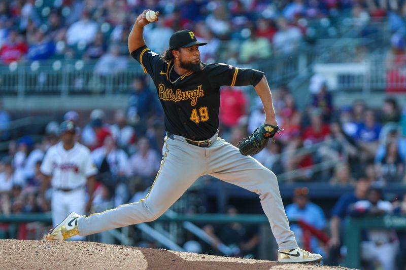 Sep 28, 2025; Cumberland, Georgia, USA; Pittsburgh Pirates pitcher Yohan Ramírez (49) pitches the ball against the Atlanta Braves during the eighth inning at Truist Park. Mandatory Credit: Jordan Godfree-Imagn Images