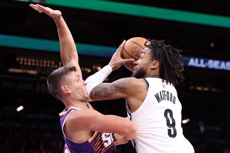 PHOENIX, ARIZONA - NOVEMBER 27: Trendon Watford #9 of the Brooklyn Nets drives to the basket against Grayson Allen #8 of the Phoenix Suns during the first half at Footprint Center on November 27, 2024 in Phoenix, Arizona. NOTE TO USER: User expressly acknowledges and agrees that, by downloading and or using this photograph, User is consenting to the terms and conditions of the Getty Images License Agreement.  (Photo by Chris Coduto/Getty Images)