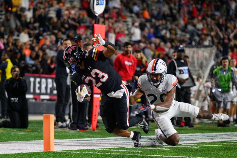 Sep 15, 2023; College Park, Maryland, USA; Maryland Terrapins running back Colby McDonald (23) is tackled by Virginia Cavaliers safety Jonas Sanker (20) during the fourth quarter at SECU Stadium. Mandatory Credit: Reggie Hildred-USA TODAY Sports