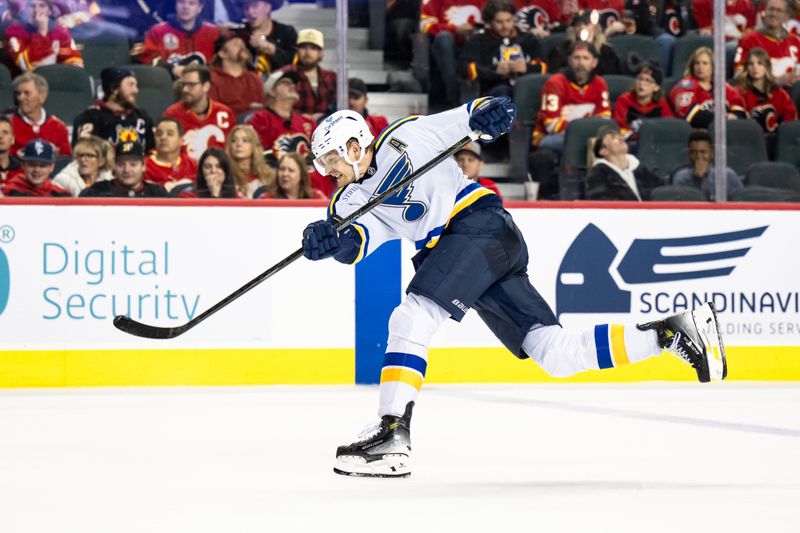 Dec 5, 2024; Calgary, Alberta, CAN; St. Louis Blues defenseman Colton Parayko (55) takes a shot against the Calgary Flames during the third period at Scotiabank Saddledome. Mandatory Credit: Brett Holmes-Imagn Images