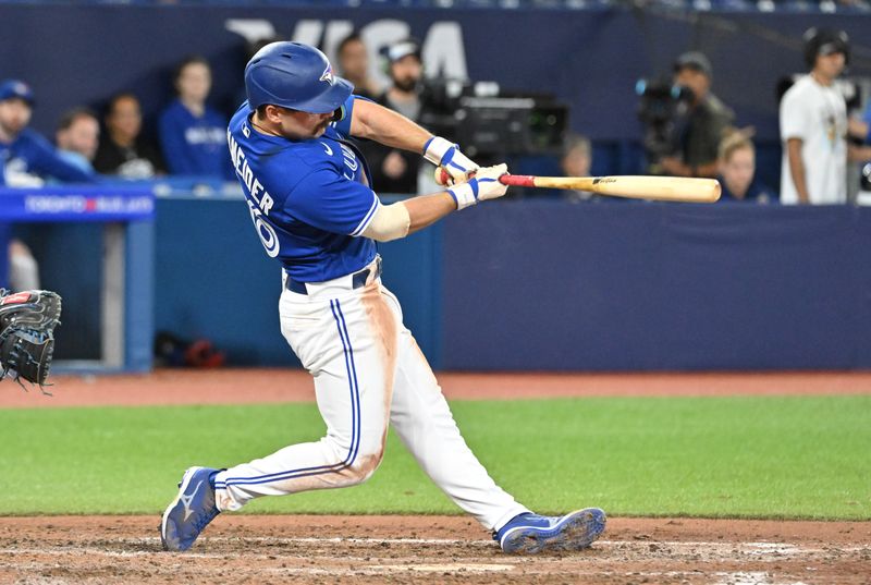 Sep 12, 2023; Toronto, Ontario, CAN;   Toronto Blue Jays left fielder Davis Schneider (36) hits a solo home run against the Texas Rangers in the ninth inning at Rogers Centre. Mandatory Credit: Dan Hamilton-USA TODAY Sports