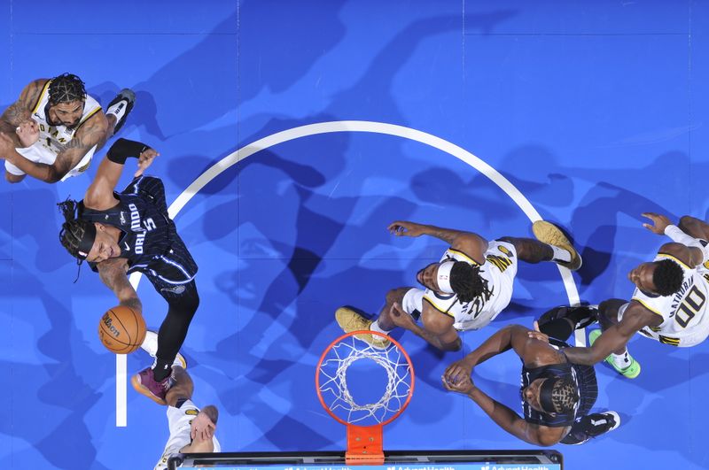 ORLANDO, FL - OCTOBER 28: Paolo Banchero #5 of the Orlando Magic drives to the basket during the game against the Indiana Pacers on October 28, 2024 at Kia Center in Orlando, Florida. NOTE TO USER: User expressly acknowledges and agrees that, by downloading and or using this photograph, User is consenting to the terms and conditions of the Getty Images License Agreement. Mandatory Copyright Notice: Copyright 2024 NBAE (Photo by Fernando Medina/NBAE via Getty Images)