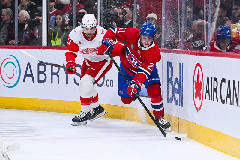 Jan 10, 2026; Montreal, Quebec, CAN; Montreal Canadiens defenseman Kaiden Guhle (21) plays the puck against Detroit Red Wings left wing James van Riemsdyk (21) during the second period at Bell Centre. Mandatory Credit: David Kirouac-Imagn Images