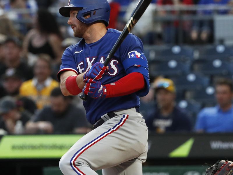 May 23, 2023; Pittsburgh, Pennsylvania, USA; Texas Rangers left fielder Robbie Grossman (4) hits a single against the Pittsburgh Pirates during the sixth inning at PNC Park. Mandatory Credit: Charles LeClaire-USA TODAY Sports