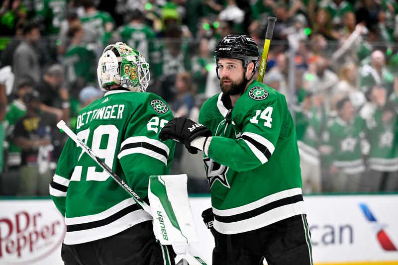 May 25, 2024; Dallas, Texas, USA; Dallas Stars goaltender Jake Oettinger (29) and left wing Jamie Benn (14) on the ice after the Dallas Stars defeat the Edmonton Oilers in game two of the Western Conference Final of the 2024 Stanley Cup Playoffs at American Airlines Center. Mandatory Credit: Jerome Miron-USA TODAY Sports