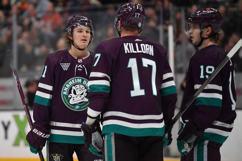 Dec 23, 2023; Anaheim, California, USA; Anaheim Ducks center Trevor Zegras (11) speaks with left wing Alex Killorn (17) and right wing Troy Terry (19) during a stoppage in play in the second period at Honda Center. Mandatory Credit: Gary A. Vasquez-USA TODAY Sports