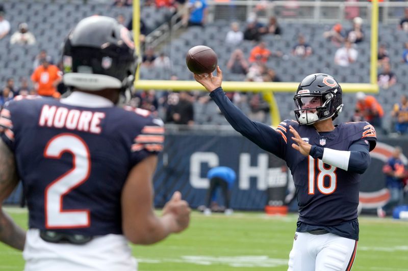 Chicago Bears quarterback Caleb Williams warms up near wide receiver DJ Moore before an NFL football game against the Los Angeles Rams on Sunday, Sept. 29, 2024, in Chicago. (AP Photo/Nam Y. Huh)