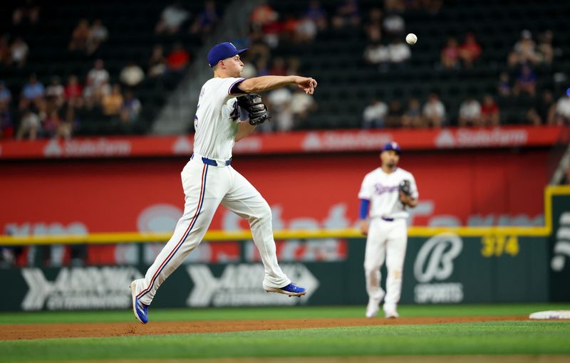 Aug 20, 2024; Arlington, Texas, USA; Texas Rangers shortstop Corey Seager (5) throws to first base during the ninth inning against the Pittsburgh Pirates  at Globe Life Field. Mandatory Credit: Kevin Jairaj-USA TODAY Sports