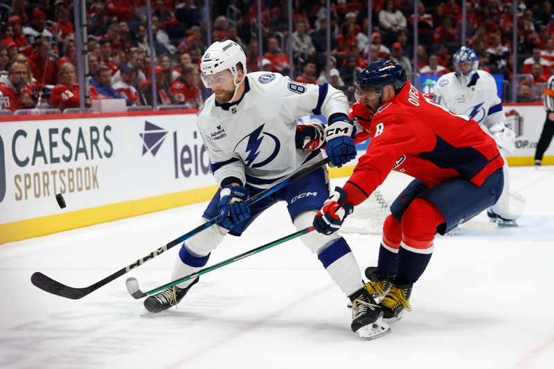 Nov 22, 2025; Washington, District of Columbia, USA; Tampa Bay Lightning defenseman Erik Cernak (81) and Washington Capitals left wing Alex Ovechkin (8) battle for the puck during the third period at Capital One Arena. Mandatory Credit: Geoff Burke-Imagn Images