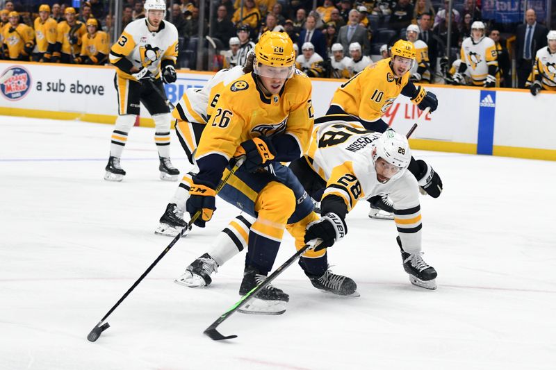 Nov 28, 2023; Nashville, Tennessee, USA; Nashville Predators center Philip Tomasino (26) handles the puck against Pittsburgh Penguins defenseman Marcus Pettersson (28) during the first period at Bridgestone Arena. Mandatory Credit: Christopher Hanewinckel-USA TODAY Sports