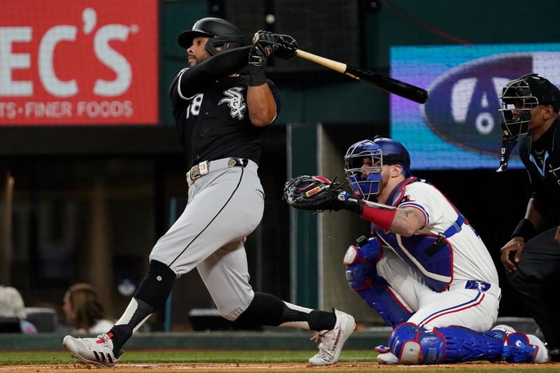 Jul 22, 2024; Arlington, Texas, USA; Chicago White Sox center fielder Tommy Pham (28) hits a solo home run during the first inning against the Texas Rangers at Globe Life Field. Mandatory Credit: Raymond Carlin III-USA TODAY Sports