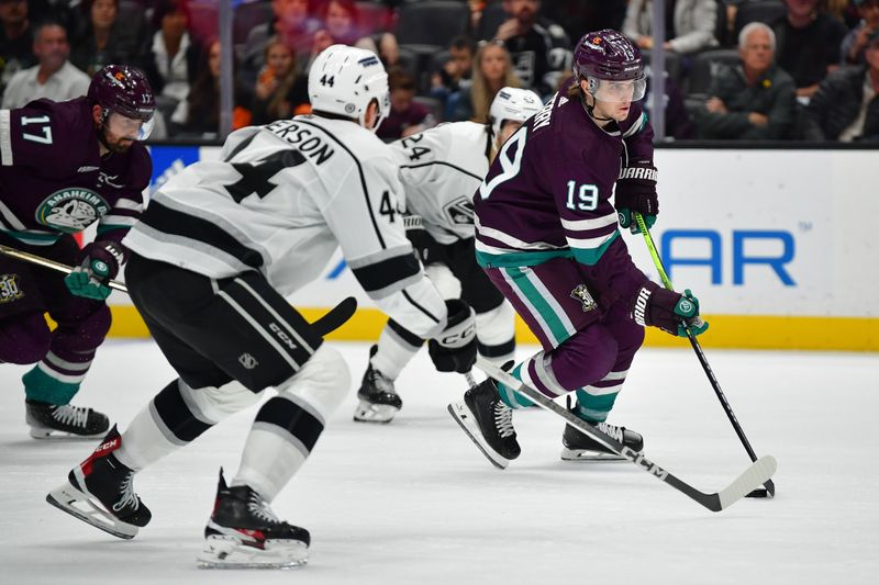 Nov 24, 2023; Anaheim, California, USA; Anaheim Ducks right wing Troy Terry (19) moves in for a shot on goal ahead of Los Angeles Kings defenseman Mikey Anderson (44) and center Phillip Danault (24) during the second period at Honda Center. Mandatory Credit: Gary A. Vasquez-USA TODAY Sports