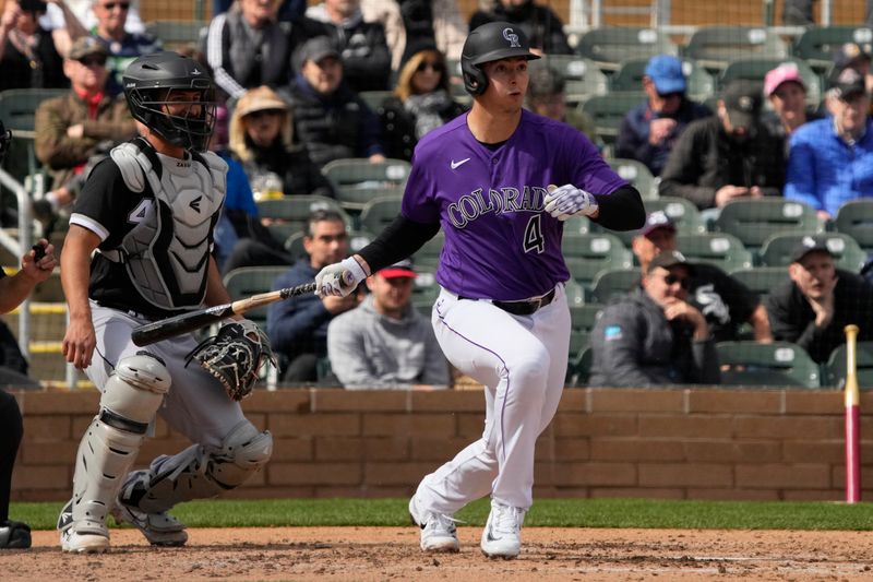 Mar 2, 2023; Salt River Pima-Maricopa, Arizona, USA; Colorado Rockies first baseman Michael Toglia (4) hits an RBI single against the Chicago White Sox in the third inning at Salt River Fields at Talking Stick. Mandatory Credit: Rick Scuteri-USA TODAY Sports