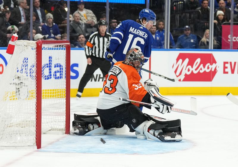 Feb 15, 2024; Toronto, Ontario, CAN; Philadelphia Flyers goaltender Samuel Ersson (33) looks for the puck as Toronto Maple Leafs right wing Mitchell Marner (16) looks for the rebound during the first period at Scotiabank Arena. Mandatory Credit: Nick Turchiaro-USA TODAY Sports