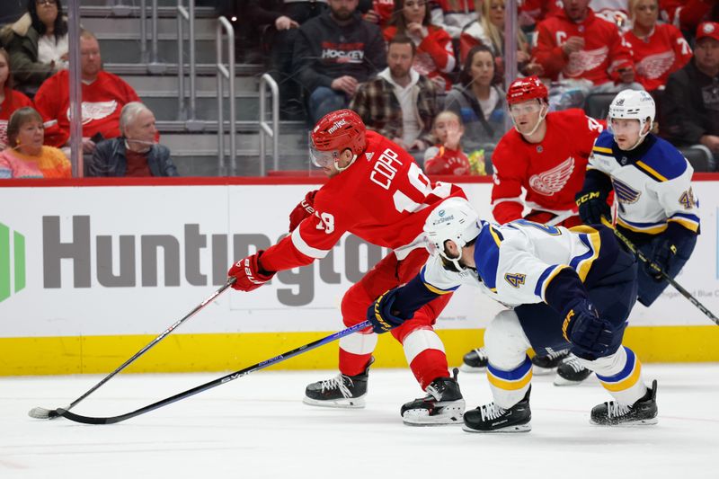 Feb 24, 2024; Detroit, Michigan, USA;  Detroit Red Wings center Andrew Copp (18) skates with the puck chased by St. Louis Blues defenseman Nick Leddy (4) in the second period at Little Caesars Arena. Mandatory Credit: Rick Osentoski-USA TODAY Sports