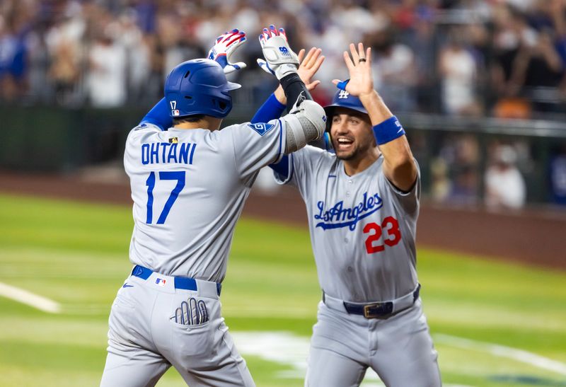May 9, 2025; Phoenix, Arizona, USA; Los Angeles Dodgers designated hitter Shohei Ohtani celebrates with teammate Michael Conforto after hitting a three run home run in the ninth inning against the Arizona Diamondbacks at Chase Field. Mandatory Credit: Mark J. Rebilas-Imagn Images