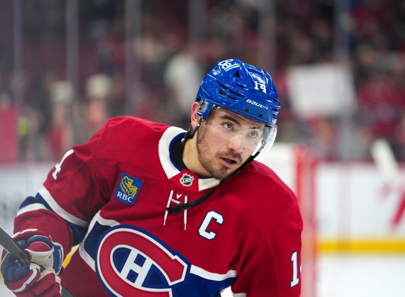Jan 20, 2026; Montreal, Quebec, CAN; Montreal Canadiens forward Nick Suzuki (14) skates during the warmup before the game against the Minnesota Wild at the Bell Centre. Mandatory Credit: Eric Bolte-Imagn Images