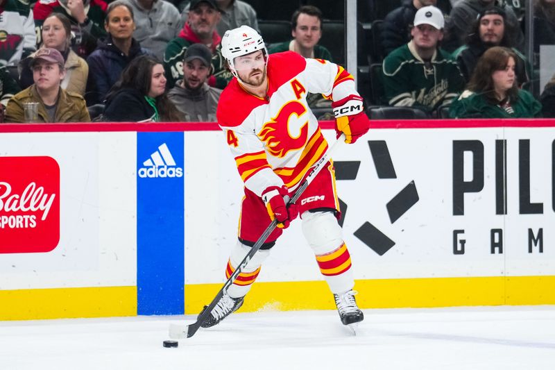 Jan 2, 2024; Saint Paul, Minnesota, USA; Calgary Flames defenseman Rasmus Andersson (4) passes during the first period against the Minnesota Wild at Xcel Energy Center. Mandatory Credit: Brace Hemmelgarn-USA TODAY Sports