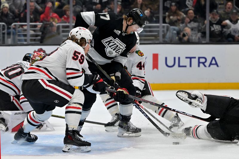 Dec 4, 2025; Los Angeles, California, USA;  Los Angeles Kings left wing Warren Foegele (37) and Chicago Blackhawks left wing Tyler Bertuzzi (59) battle for control of the puck in front of the net during the second period at Crypto.com Arena. Mandatory Credit: Jayne Kamin-Oncea-Imagn Images