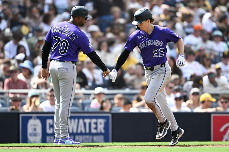 Sep 14, 2025; San Diego, California, USA; Colorado Rockies right fielder Mickey Moniak (22) is congratulated by Andy González (70) after hitting a solo home run during the fourth inning against the San Diego Padres at Petco Park. Mandatory Credit: Denis Poroy-Imagn Images