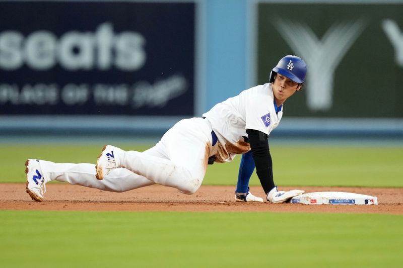 May 7, 2024; Los Angeles, California, USA; Los Angeles Dodgers designated hitter Shohei Ohtani (17) slides into second base in the first inning against the Miami Marlins  at Dodger Stadium. Mandatory Credit: Kirby Lee-USA TODAY Sports